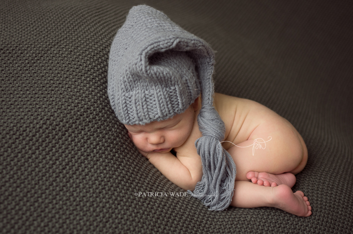 cuddly newborn with hat